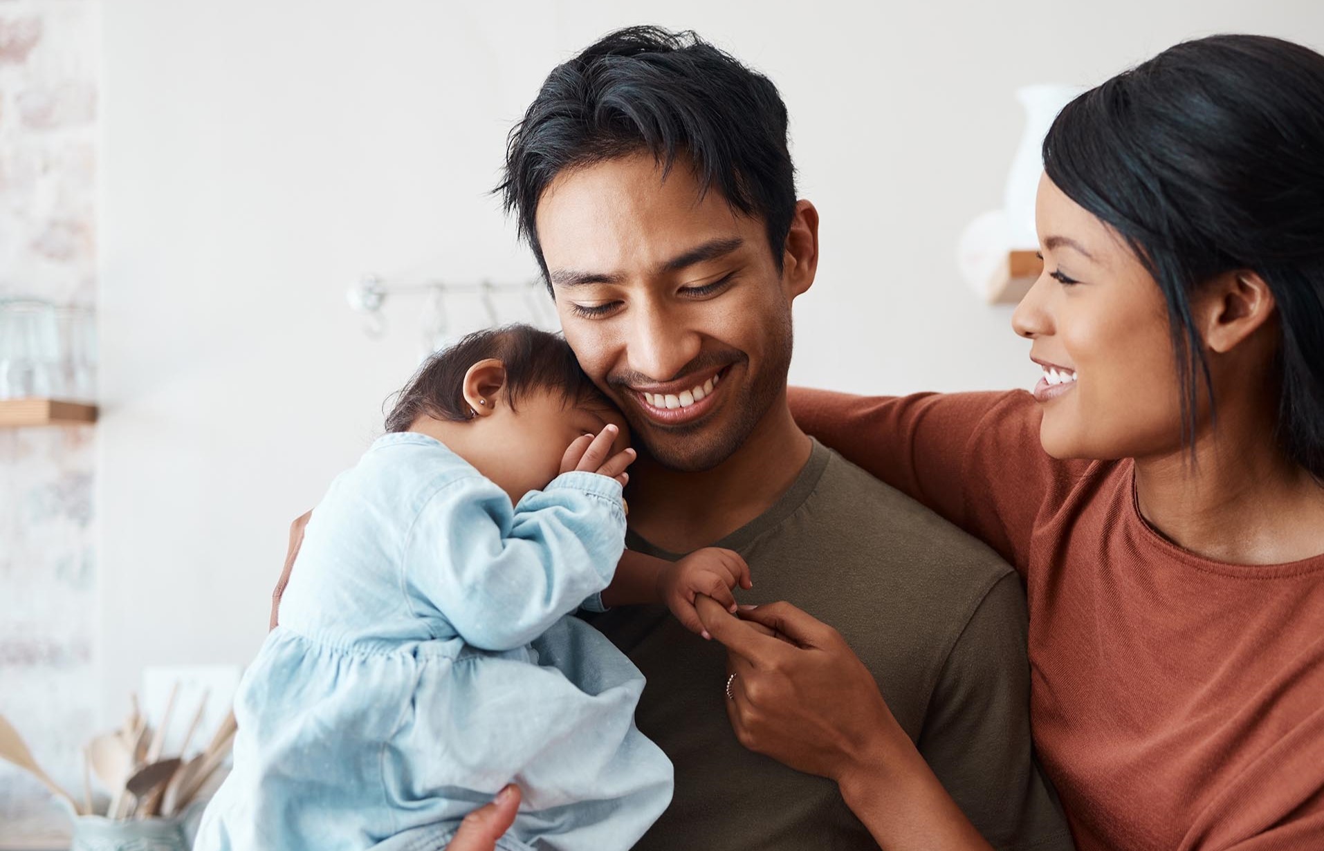 young couple hugging baby