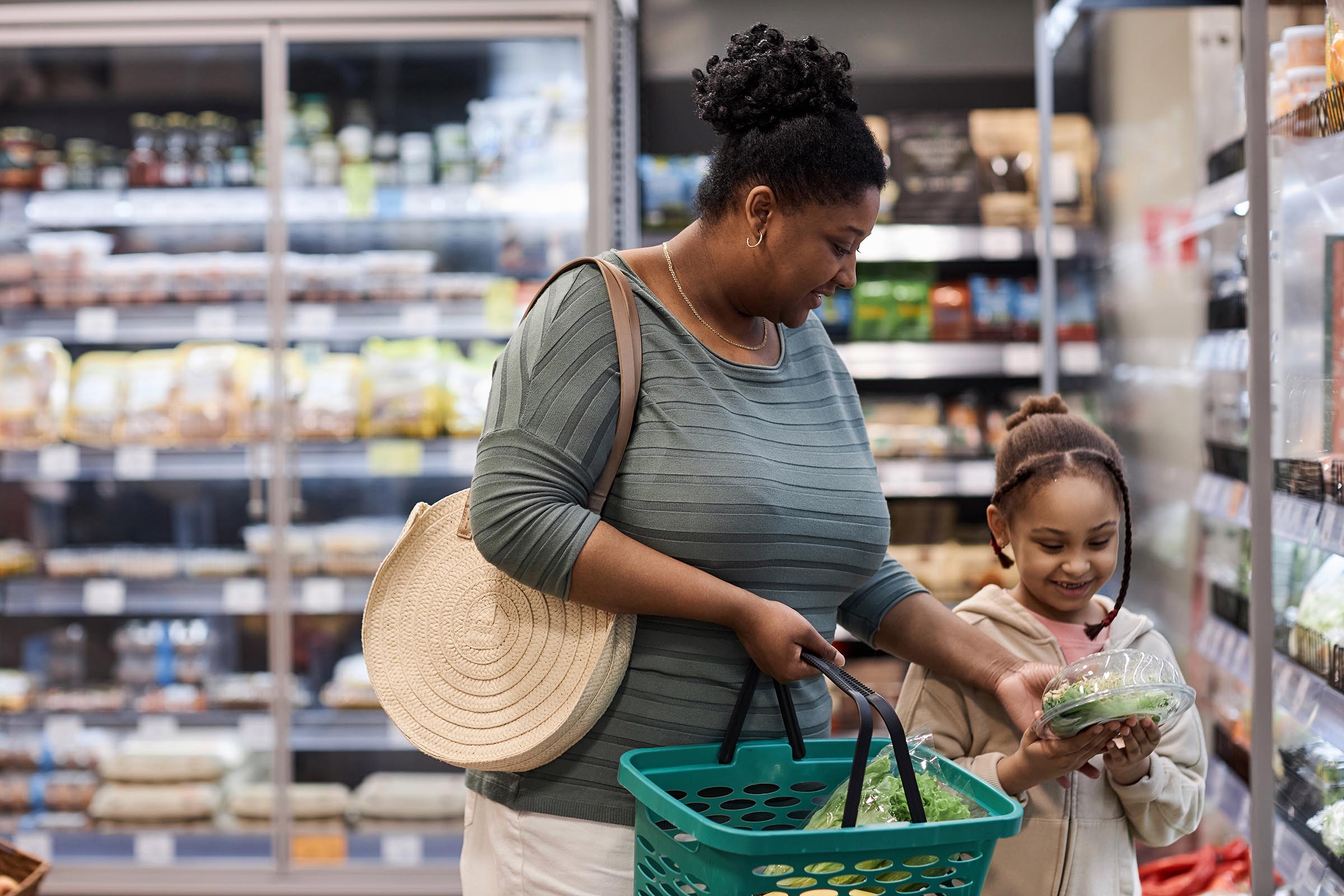 young african amercian mother and daughter shopping happily