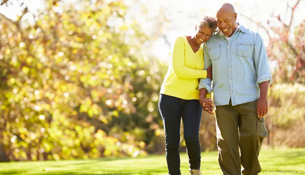 smiling older African-American couple strolling