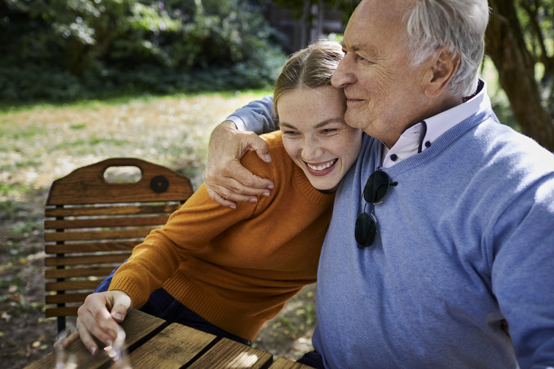 grandfather hugging his teenage granddaughter