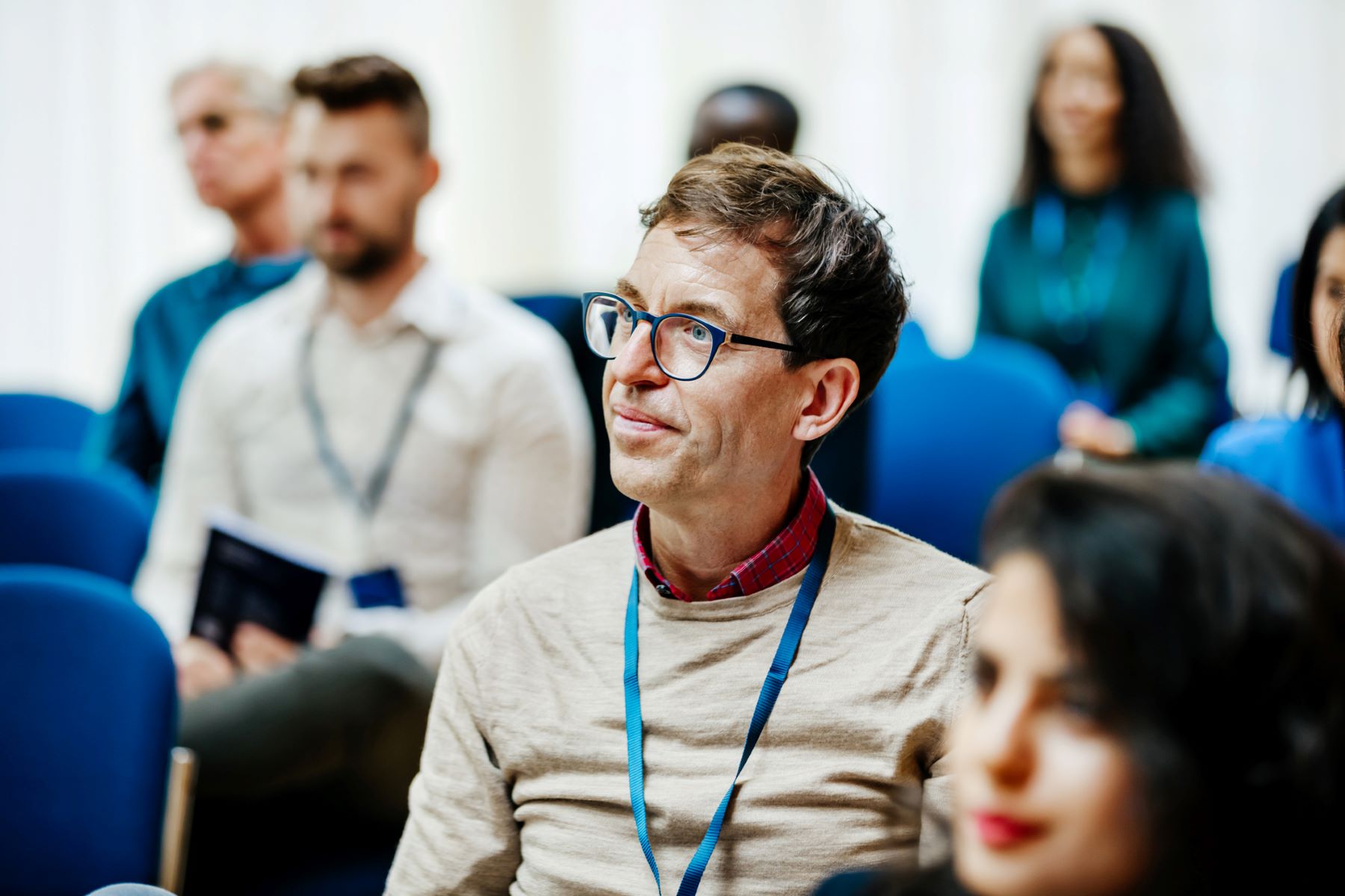 Male professional listening intently to a lecture